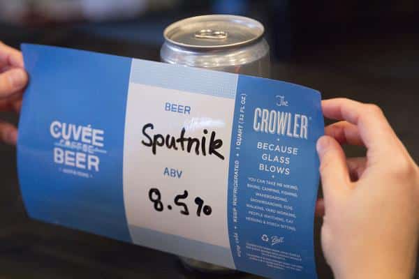 Putting Label on Cuvee Crowler