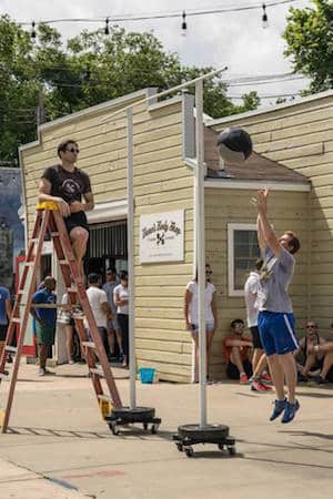 Dane Krager judges med ball toss at Dane's Body Shop