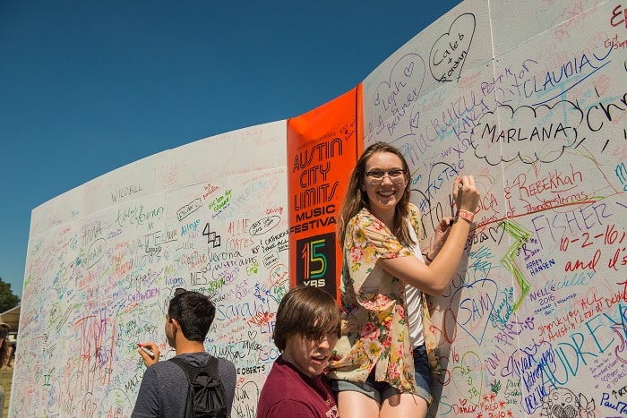 Kids Sign the ACL Fest Anniversary Wall