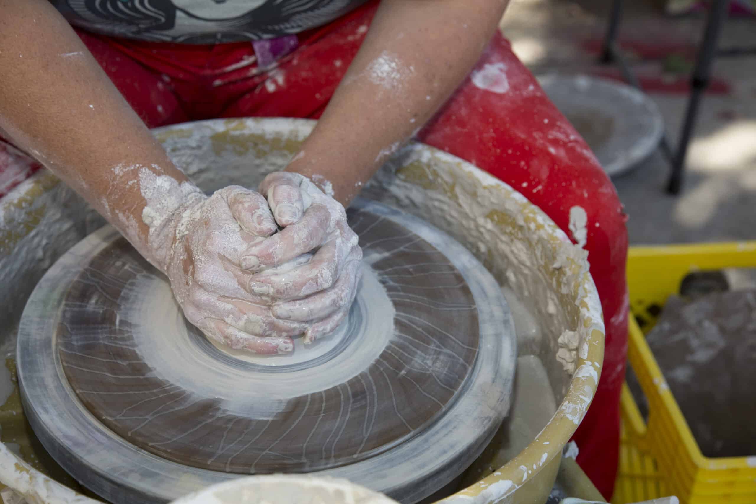 Creating ceramic bowl on pottery wheel