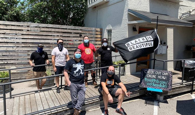 Marvis Dixon holding his flag at Oddwood Ales