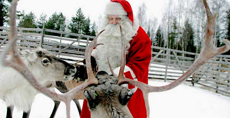 Santa feeding reindeer for Top Holiday Kids Events This Weekend in Austin. 